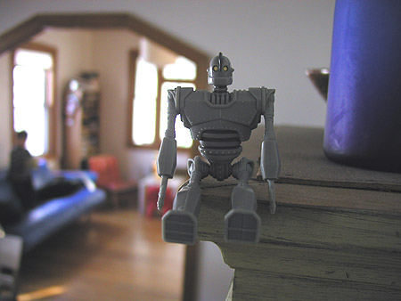 iron giant looking down from atop the curio cabinet