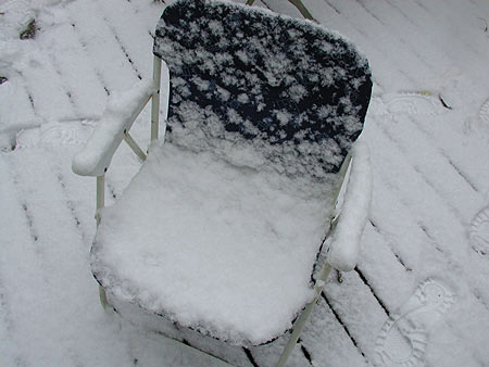 snow covered lawn chair